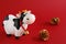 Toy bull with Golden fir cones on a red background. Symbol of the Chinese New year 2021. New year`s mood.