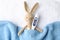 Toy bunny with thermometer on towel background