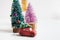 Toy car with chrstmas tree and three small colorful christmas trees