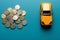 Toy car and coins buying concept, miniature model car and coins making a purchase