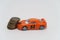 Toy car crashed into a stack of coins, auto insurance symbol