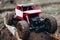 Toy car roading on wooden beams through mud