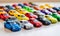 The toy cars formed a colorful convoy on the white table, ready for a pretend road trip