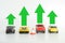 Toy cars models with green arrows suggesting automotive industry growth