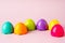 Toy colored plastic eggs on a pink background. Toy bright Easter background. Montessori Easter concept. Easter eggs for children