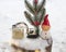 toy excavator , souvenir figurine of elf,coniferous branch stand in snow in composition on theme of New Year