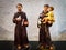 Toy figure of saint Anthony holding a boy child and saint Francis holding a dove bird and bible