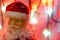 Toy, figurine, Santa Claus. Toy Santa Claus on the background of garland lights. Face, parts of the body of Santa Claus. New Year