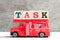 Toy fire ladder truck hold block in word task on wood background