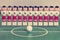 Toy football players stand in the field in a row and a ball in the center, retro effect