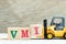 Toy forklift hold block I to complete word VMI abbreviation of vendor managed inventory on wood background