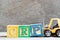 Toy forklift hold block P to complete word CRP abbreviation of C-Reactive Protein Test on wood background