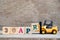 Toy forklift hold block R to word 30apr on wood background Concept for calendar date 30 in month april