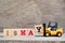 Toy forklift hold block Y to complete word 16 may on wood background & x28;Concept for calendar date for month May& x29;