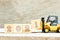 Toy forklift hold letter block 1 to word 2021 on wood background