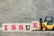 Toy forklift hold letter block e to complete word issue on wood background