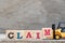 Toy forklift hold letter block M to complete word claim