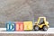 Toy forklift hold letter block Y to word DIY abbreviation of do it yourself on wood background