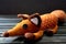 Toy Fox from the cartoon The Little Prince on a dark wooden background