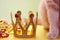 Toy Golden crown, Christmas beads pile and part of a red cat close-up. Pets and holidays