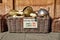 Toy horned helmets in traditional Norwegian style in wicker basket are sold on the street in front of a souvenir gift