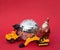 Toy loader and excavator models, Santa souvenir figurine, mirror disco ball on red background