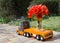 Toy lorry on a bright sunny day carries a large bouquet of red tulips for a gift