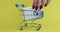 Toy metal cart with credit bank card on yellow background closeup 4k movie