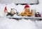 toy metal excavator, truck loaded with gingerbread tree, decorative snowman, warehouse loader standing on snow