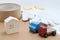 Toy mini car trucks, packing tape, card boards, cotton work gloves and house on white background.