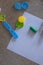 Toy molds for use with yellow and green blue plasticine. Children toys on the floor with green clay