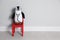 Toy penguin with eyeglasses and stethoscope near wall, space for text. Pediatrician practice