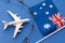 Toy plane, flag and barbed wire on a colored background, the concept of violating the Australian air border