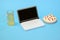 toy plastic laptop with beer and pizza on pastel blue background