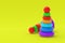 Toy pyramid towers on yellow background. Children education. Educational games. Preschool development