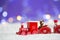 Toy red wooden locomotive on white knitted fabric on purple back