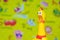 Toy rubber shriek yellow chicken on blur toy background in messy