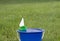 Toy sailboat floating in a bucket
