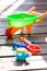 Toy sand pails and shovels over on wooden terrace on sunny day