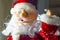 Toy Santa Claus. Santa Claus close-up, on a dark background. Festive man in a red suit and with a beard