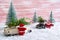 Toy Santas met in the forest, standing near the cars that deliver Christmas trees. Magic atmosphere. Christmas celebration concept