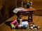 Toy sewing machine on the wooden table and colorful threads and buttons on the front of it