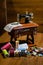 Toy sewing machine on the wooden table and colorful threads and buttons on the front of it