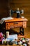 Toy sewing machine on the wooden table and colorful threads and buttons on the front of it