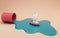 Toy ship floating on spilled paint