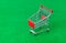 Toy shopping cart on green