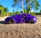 Toy small purple car in the sandbox on the playground