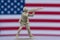 Toy soldier in front of American flag with desert brown color