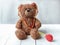 Toy stethoscope and teddy bear on wooden table. Doctor tool
