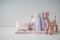 Toy with towel, cotton swabs and cosmetics for baby on white table